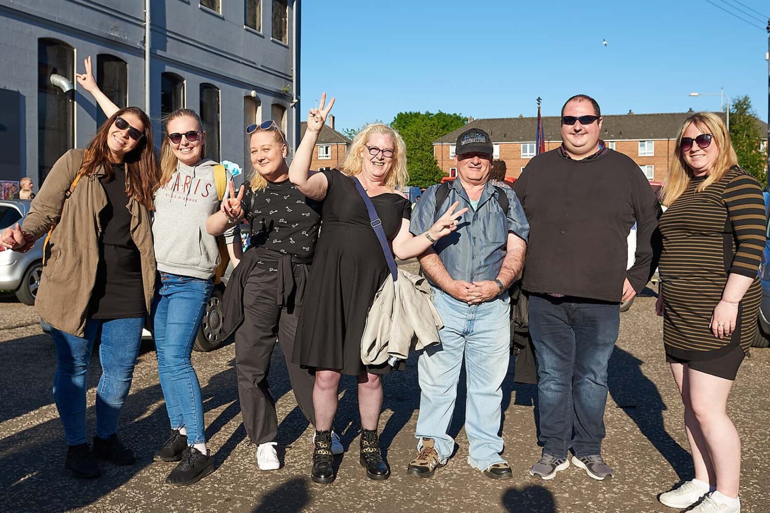 A group of people posing for a picture in front of a building.