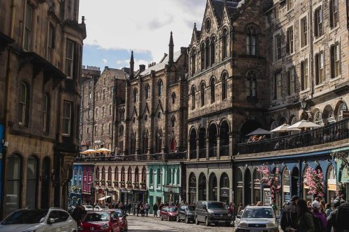 A street in Edinburgh filled with parked cars, attracting Harry Potter fans.