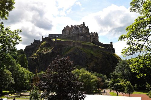 Visit Edinburgh castle, one of the iconic castles in the UK, as you enjoy breathtaking views from the top of a hill.