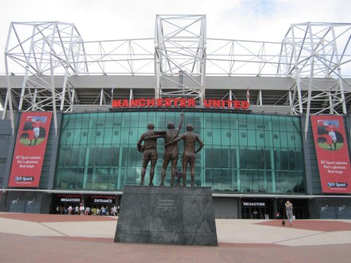 The UK-based Manchester United stadium is a must-visit location for any football enthusiast, boasting striking statues in front of it.